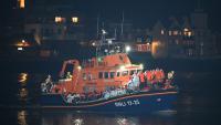 Two boats carrying up to 120 migrants dock at UK town after crossing Channel as protesters chant ‘send them back’