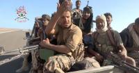 Yemeni government fighters shown driving vehicles over Houthi opponents
