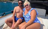 Gemma Collins poses in a plunging swimsuit as she joins shirtless fiancé Rami Hawash on an Italian boat trip after revealing his 'drinking problem' pushed them to breaking point