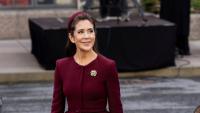Queen Mary of Denmark is regal in red at the opening of parliament as she returns from her late father's memorial service