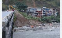 Flood-triggered damage to bridge halts transportation; tourism and trade affected