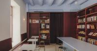 burgundy wood and blue ceilings shape café, bookshop, and wine bar in valencia