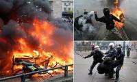 Student riots spread to Belgium as hundreds of hooded protesters clash with police sparking 'total chaos' in Brussels