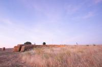 straw walls shape amphitheater, experimental garden and walking path in rural spain