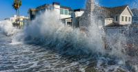 Dual tropical storms hit both US coasts with floods and outages