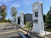 A charging network built by eight rival automakers passed 180 live sites this month, doubling its US footprint since January, while independent trackers show the industry leader’s charger share keeps slipping
