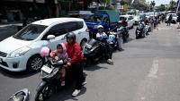 Holiday island hit by fuel crisis as scooter riders & motorists form huge queues at petrol stations