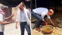 German diplomat meets farmer in Indian village, wears gamcha, handles cow dung