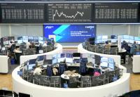Global stocks edge lower as dollar heads for weekly loss