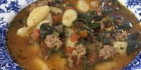 Italian gnocchi and sausage soup with spinach and arugula