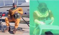 Croatian diver delivers message to world leaders from seabed in 90kg diving suit and copper helmet