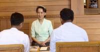 Rare photos of Myanmar’s ex-leader Aung San Suu Kyi show her receiving books sent by King Charles