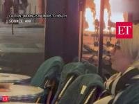 France: Couple sips drinks unfazed as flames rise in background during Paris student riots