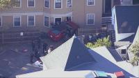 Crews respond after car crashes into building in Jamaica Plain