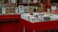 French Bookstore Stands Untouched Amid Riots Even as Owner Sits Behind 'Welcome' Sign