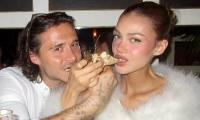 Brooklyn Beckham and his wife Nicola Peltz put on a loved-up display feeding each other pizza in cosy snaps