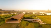 A simple timber envelope conceals the scale and drama of this waterfront house in Brazil