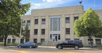 Trial set in embezzlement case, plea accepted in assault case