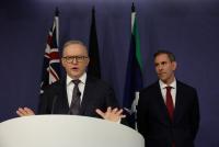Australia’s treasurer warns of softer growth, higher unemployment