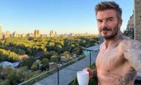 David Beckham, 51, shows off his ripped physique in a shirtless selfie as he enjoys a morning coffee on his balcony in New York