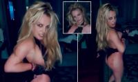 Britney Spears shows off a mysterious red design on her buttock as she dances in a barely-there thong lace bodysuit