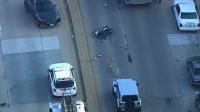 Baltimore police shut down Moravia Road as paramedics treat motorcyclist hit by car