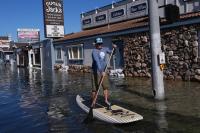 King tides inundate streets and flood homes and businesses along both US coasts