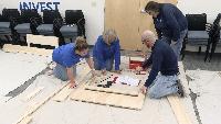 Local bank employees volunteer to build beds for children in need