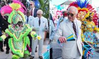 Dancing King! Charles gets in the carnival spirit during Bahamas visit and enjoys a celebratory Junkanoo street parade
