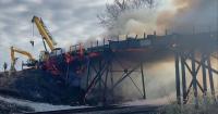 Fire departments battle bridge fire northeast of Gibbs, Missouri