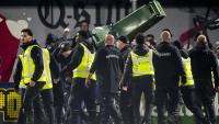 Footie fans invade pitch and throw WHEELIE BIN at each other as Dutch cup clash descends into chaos