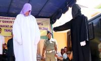 The first non-Muslim to be caned under Indonesia's sharia law - a Christian 60-year-old woman given 28 lashes for selling alcohol
